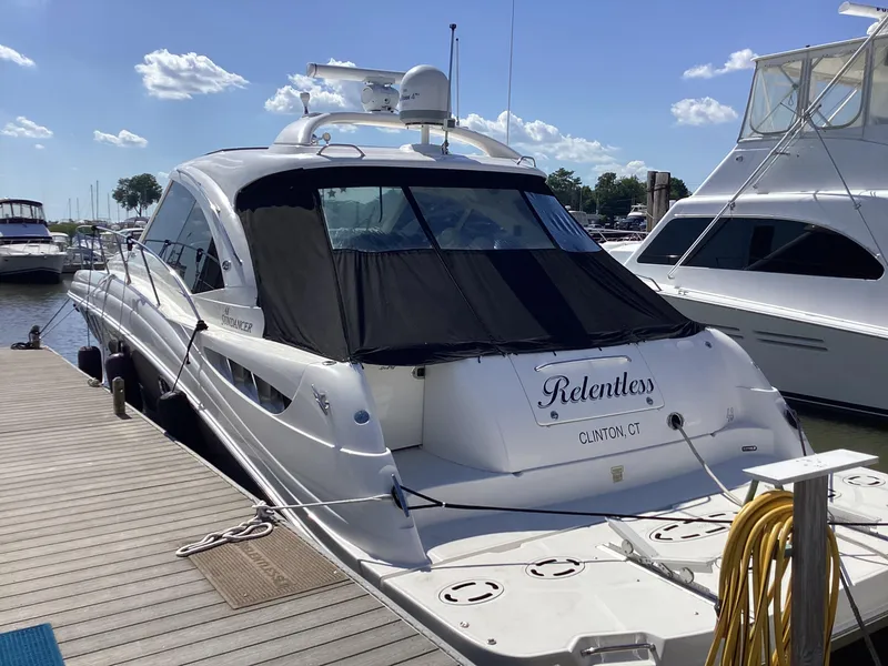 Slide: The Image of 2006 Sea Ray 48 Sundancer yacht docked, named "Relentless," in Clinton, CT marina. - 4