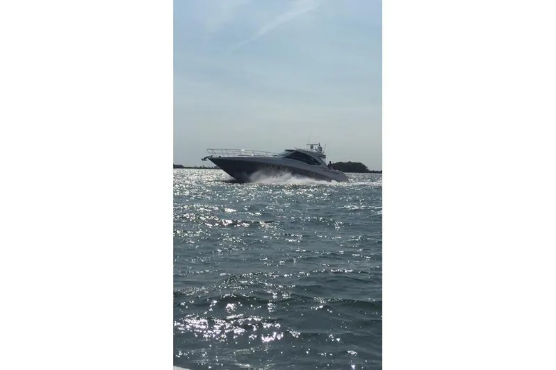 Slide: The Image of 2006 Sea Ray 48 Sundancer cruising on open water under a clear sky. - 44