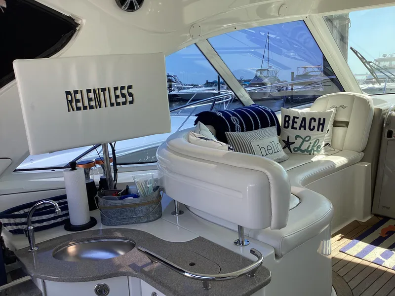 Slide: The Image of Interior of 2006 Sea Ray 48 Sundancer yacht with plush seating and nautical decor. - 7