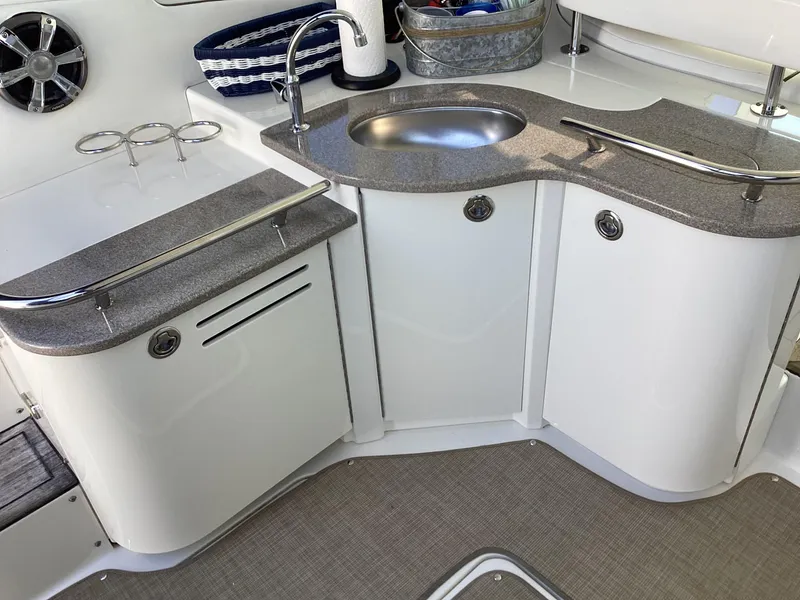 Slide: The Image of 2006 Sea Ray 48 Sundancer yacht kitchenette with sink and storage cabinets. - 8