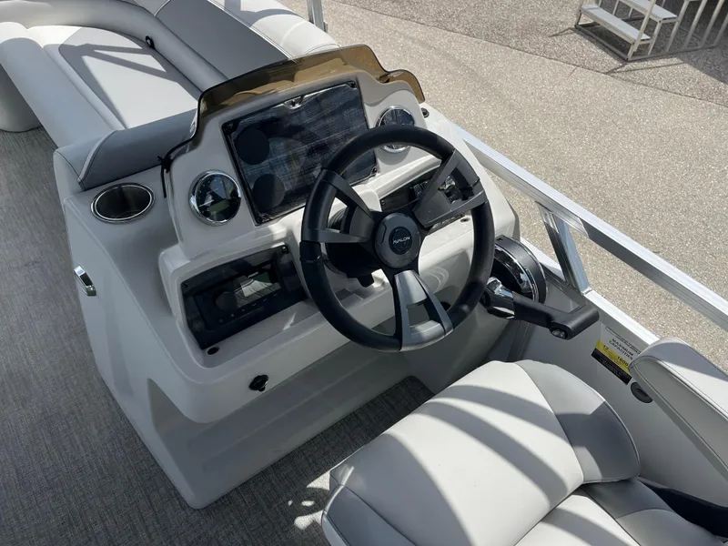 Slide: The Image of 2025 Avalon 2385 Venture 85 Quad Lounger boat dashboard with steering wheel and controls. - 10