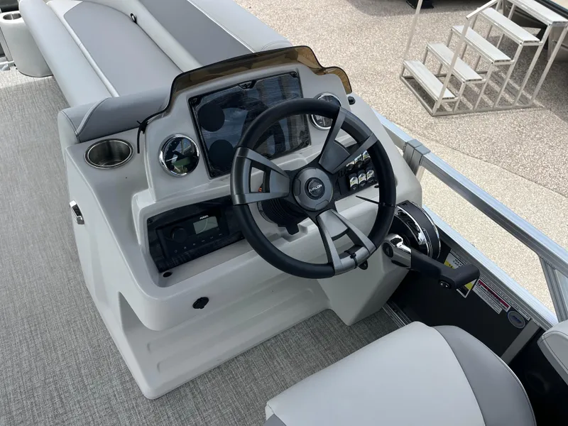 Slide: The Image of 2025 Avalon 2385 Venture 85 Quad Lounger boat helm with steering wheel and controls. - 10