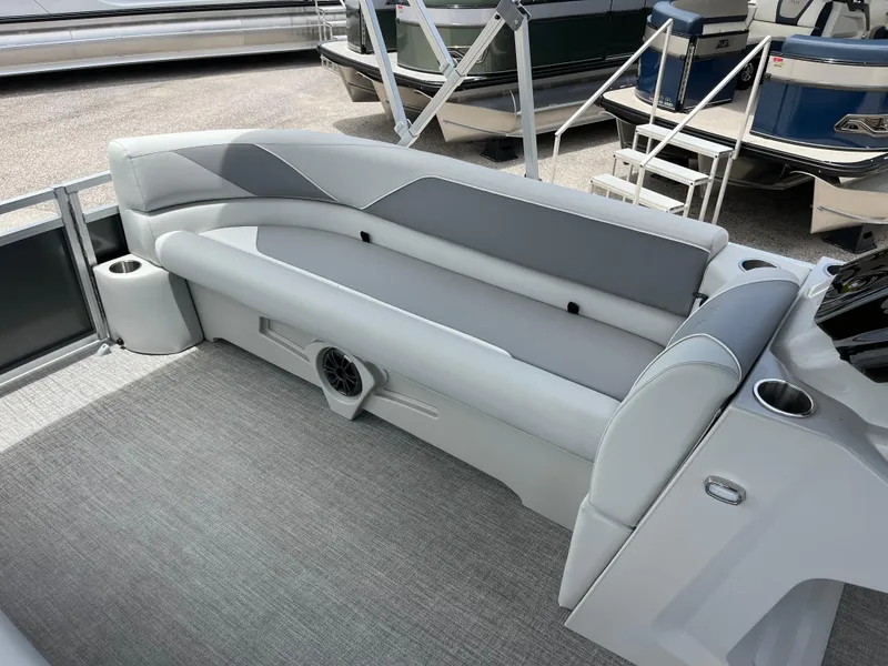 Slide: The Image of 2025 Avalon 2385 Venture 85 Quad Lounger interior with gray seating and speaker system. - 12