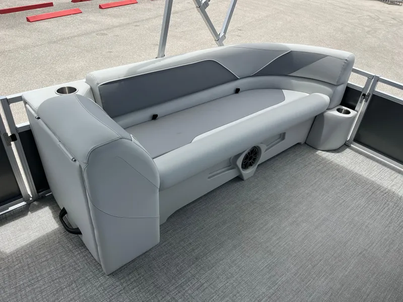 Slide: The Image of 2025 Avalon 2385 Venture 85 Quad Lounger interior with gray seating and cup holders. - 13