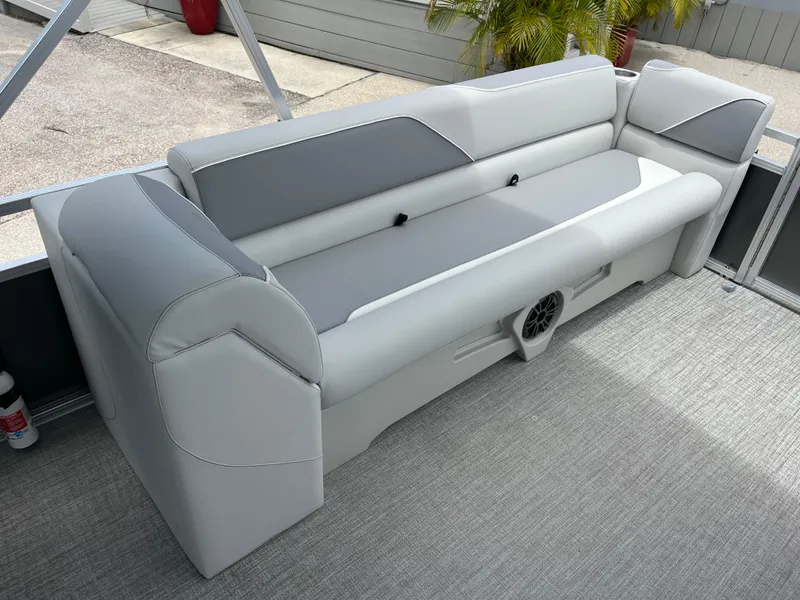 Slide: The Image of 2025 Avalon 2385 Venture 85 Quad Lounger interior with gray seating and speaker. - 18