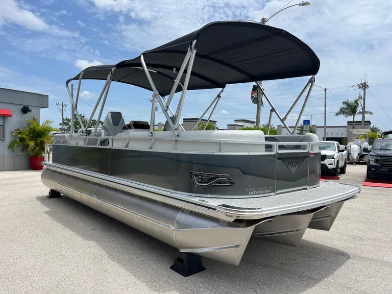 Slide: The Image of 2025 Avalon 2385 Venture 85 Quad Lounger Tri Toon boat with canopy, parked outdoors. - 3