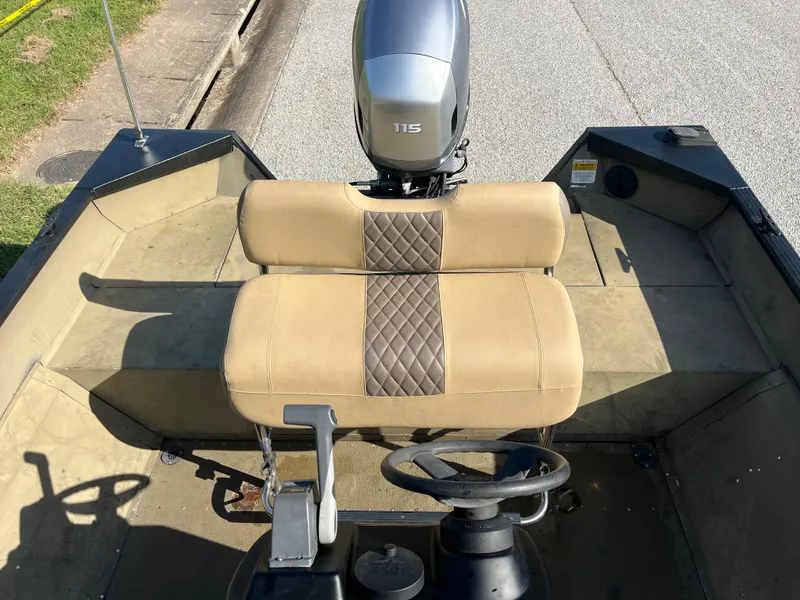 Slide: The Image of 2011 G3 2072cc boat interior with beige and brown seating, parked on a street. - 13