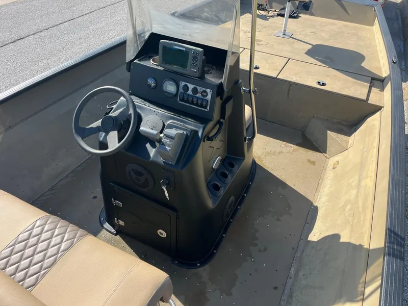 Slide: The Image of 2011 G3 2072cc boat interior with beige diamond-stitched seats and console. - 28