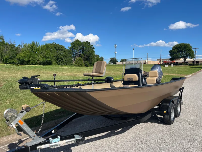 Slide: The Image of 2011 G3 2072cc boat on trailer, parked outdoors under a clear blue sky. - 3