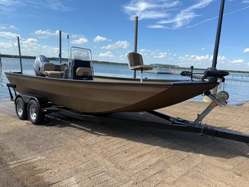 Slide: The Image of 2011 G3 2072cc boat on trailer by a lake under a blue sky. - 35