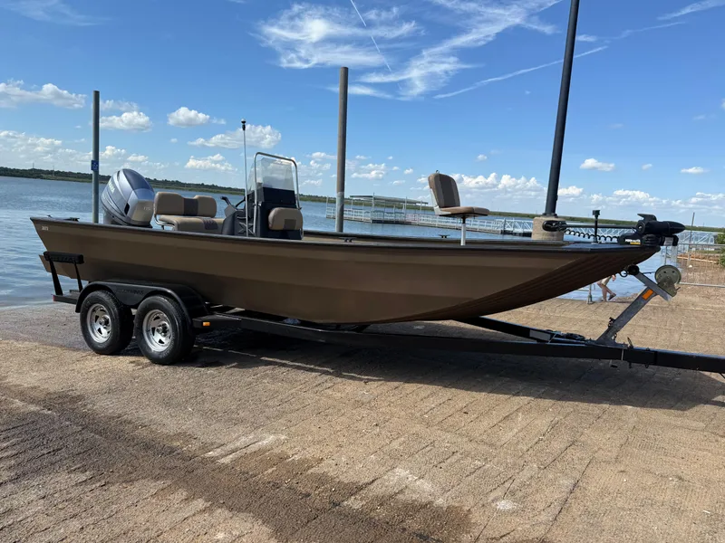 Slide: The Image of 2011 G3 2072cc boat on trailer by a lake under a clear sky. - 36