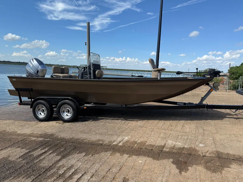 Slide: The Image of 2011 G3 2072cc boat on trailer by a lake under a blue sky. - 37