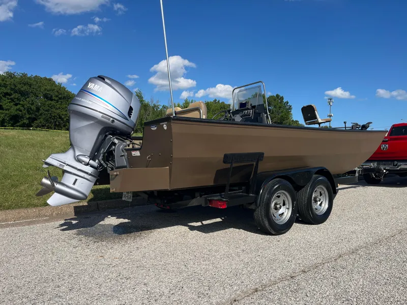 Slide: The Image of 2011 G3 2072cc boat with Yamaha outboard motor on trailer, parked outdoors. - 4