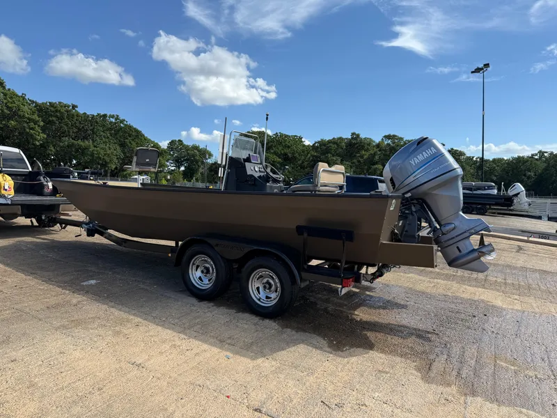 Slide: The Image of 2011 G3 2072cc boat on trailer with Yamaha outboard motor, parked outdoors. - 47