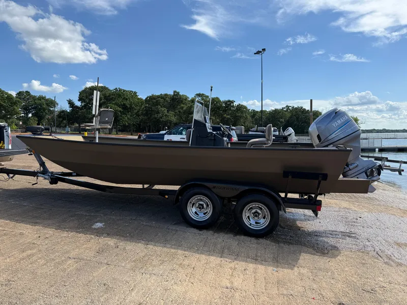Slide: The Image of 2011 G3 2072cc boat on trailer with Yamaha outboard motor, parked near a lake. - 48