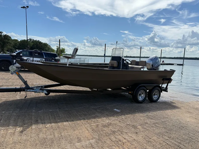 Slide: The Image of 2011 G3 2072cc boat on trailer by a lake under a cloudy sky. - 49