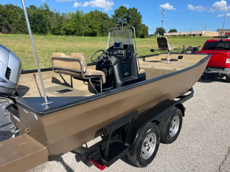 Slide: The Image of 2011 G3 2072cc boat on trailer, parked outdoors under a clear blue sky. - 5
