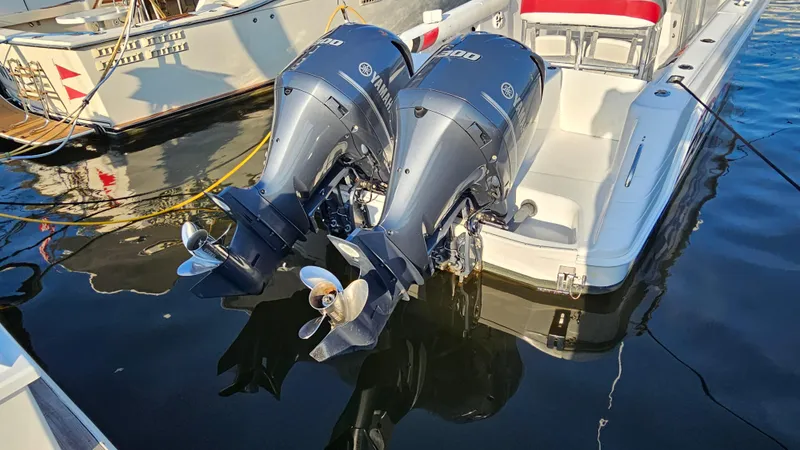 Slide: The Image of 1999 Donzi 35 ZF boat with twin Yamaha outboard engines docked on water. - 10