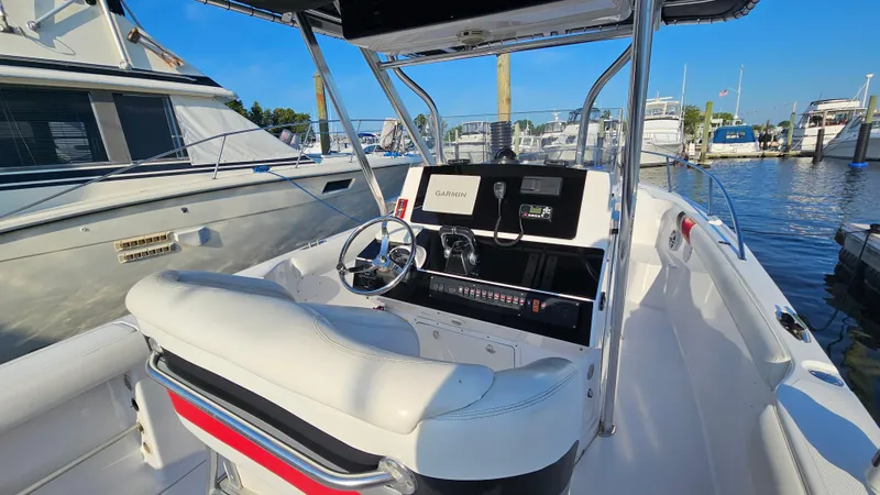 Slide: The Image of 1999 Donzi 35 ZF boat cockpit with steering wheel and Garmin navigation system. - 12