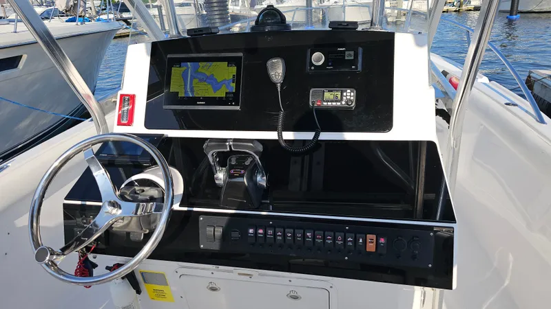 Slide: The Image of 1999 Donzi 35 ZF boat dashboard with navigation and communication equipment. - 13