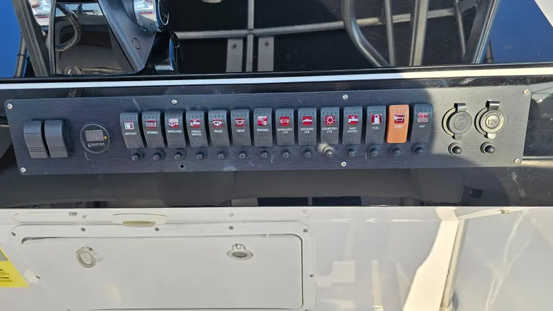 Slide: The Image of Control panel of a 1999 Donzi 35 ZF boat with various switches and outlets. - 16