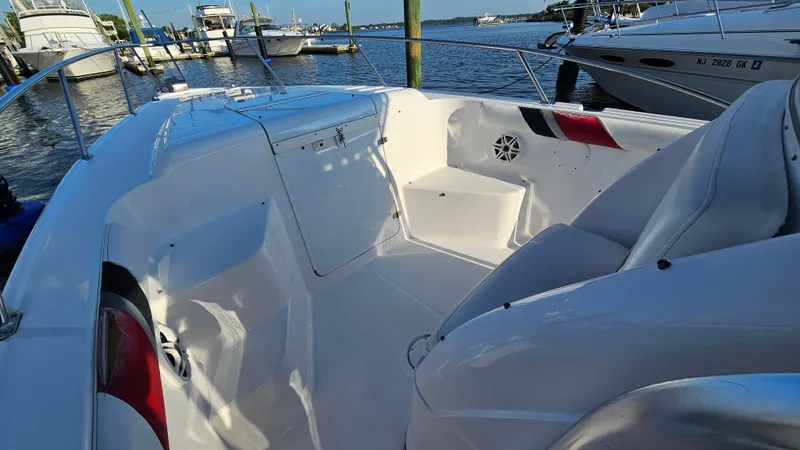 Slide: The Image of 1999 Donzi 35 ZF boat interior with white seating and open deck at marina. - 18