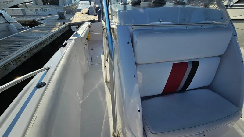 Slide: The Image of 1999 Donzi 35 ZF boat interior with white seating and red-black stripe design. - 19
