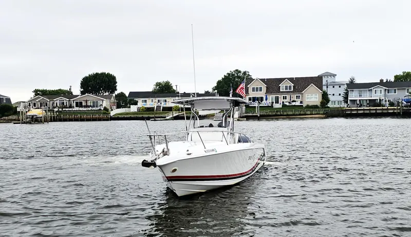 Slide: The Image of 1999 Donzi 35 ZF boat cruising near waterfront homes. - 2