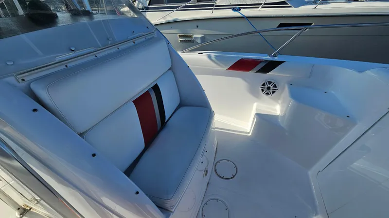 Slide: The Image of 1999 Donzi 35 ZF boat interior with white seating and red accents. - 20