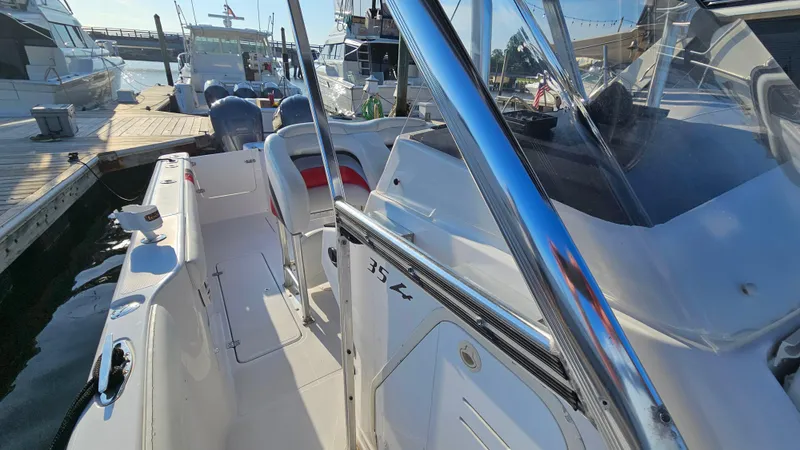 Slide: The Image of 1999 Donzi 35 ZF boat docked at marina, featuring sleek design and spacious interior. - 22