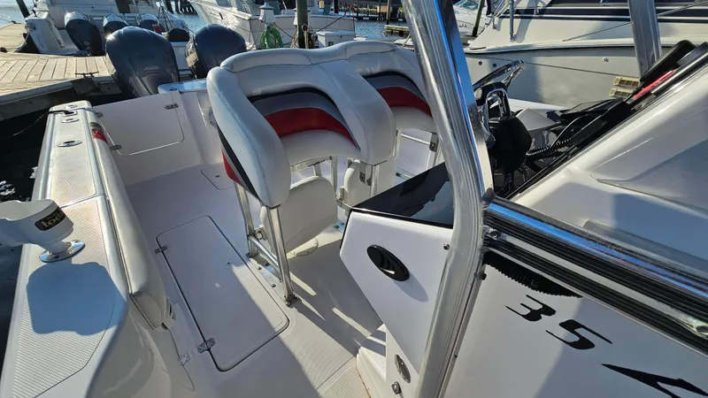 Slide: The Image of 1999 Donzi 35 ZF boat interior with sleek seating and control panel at a marina. - 23