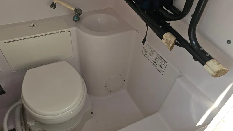 Slide: The Image of 1999 Donzi 35 ZF boat bathroom with toilet and sink. - 24