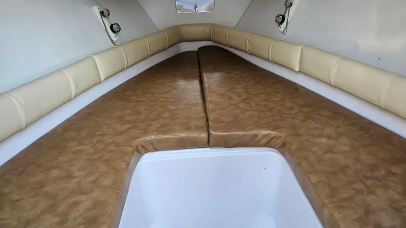 Slide: The Image of 1999 Donzi 35 ZF cabin interior with tan cushions and white accents. - 25