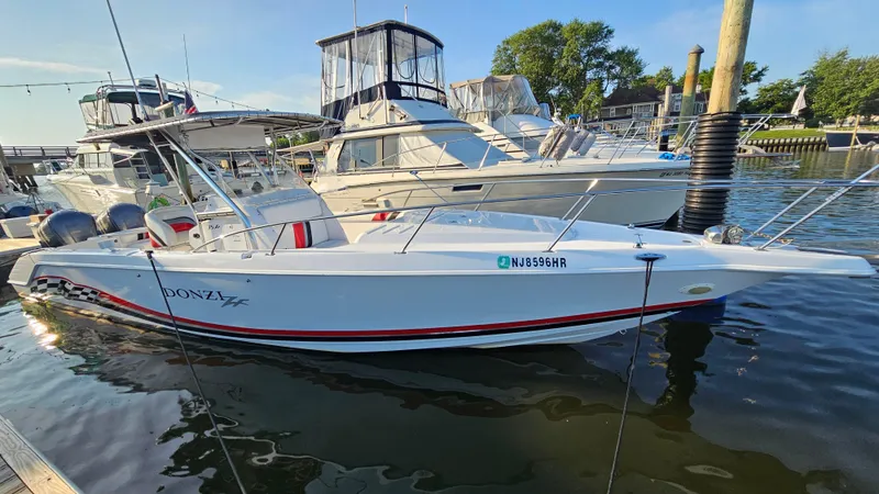 Slide: The Image of 1999 Donzi 35 ZF boat docked in marina, featuring sleek design and vibrant accents. - 6