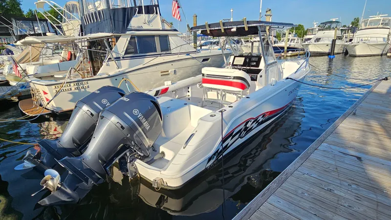 Slide: The Image of 1999 Donzi 35 ZF boat docked, featuring twin Yamaha outboard engines. - 8