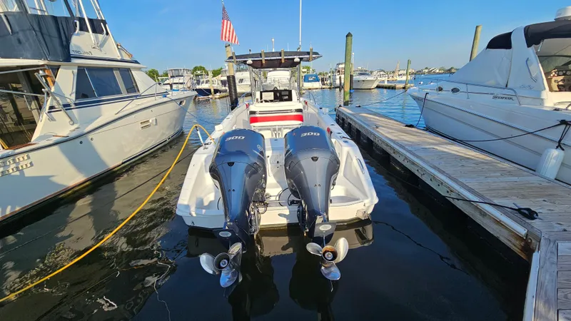 Slide: The Image of 1999 Donzi 35 ZF boat docked with twin outboard engines in a marina. - 9