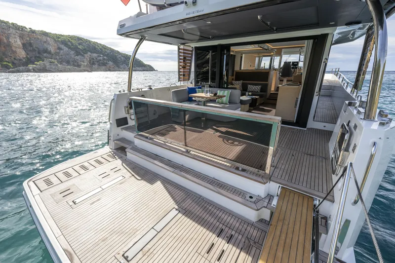 Slide: The Image of 2026 Beneteau Swift Trawler 54 yacht with open deck and scenic ocean view. - 19