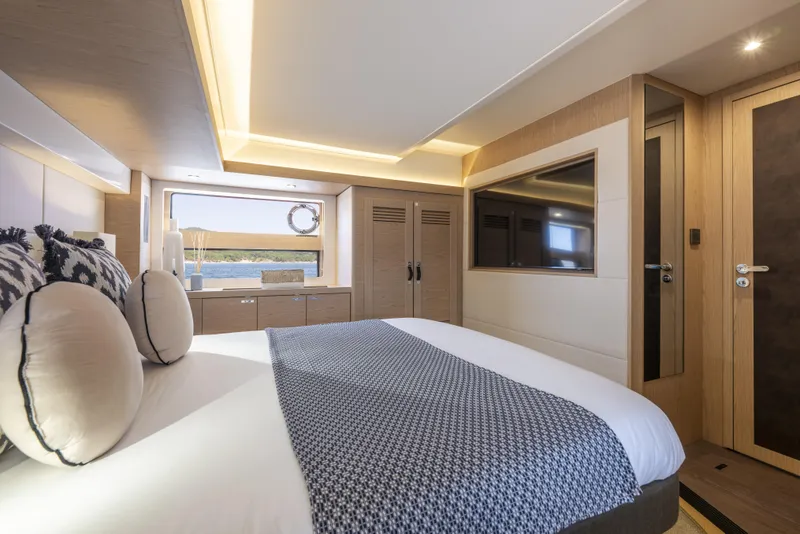 Slide: The Image of Luxurious bedroom interior of 2026 Beneteau Swift Trawler 54 yacht, featuring modern design and elegant decor. - 25