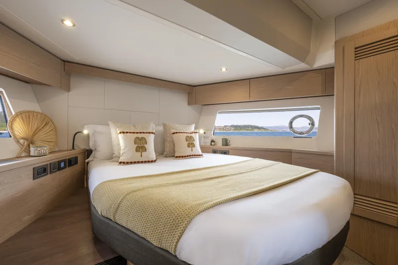 Slide: The Image of Luxurious bedroom interior of 2026 Beneteau Swift Trawler 54 with scenic ocean view. - 26
