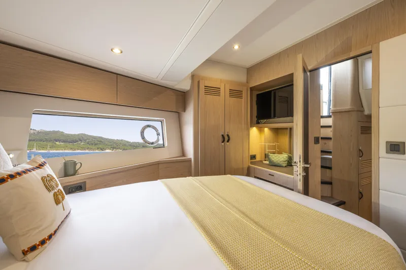 Slide: The Image of Luxurious cabin interior of 2026 Beneteau Swift Trawler 54, featuring elegant wood finishes. - 28
