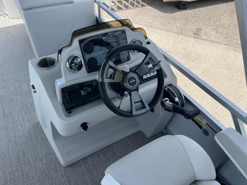 Slide: The Image of Steering console of 2025 Avalon 2385 Venture 85 Tri Toon boat, featuring modern controls. - 10