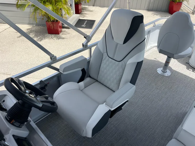 Slide: The Image of 2025 Avalon 2385 Venture boat interior with plush captain's chair and steering wheel. - 17