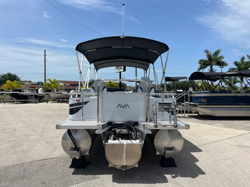 Slide: The Image of 2025 Avalon 2385 Venture 85 Tri Toon boat with canopy, parked outdoors. - 6
