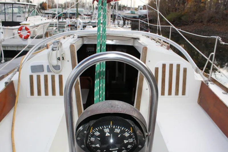 Slide: The Image of 1976 Bristol 34 sailboat cockpit with compass, docked at marina. - 29