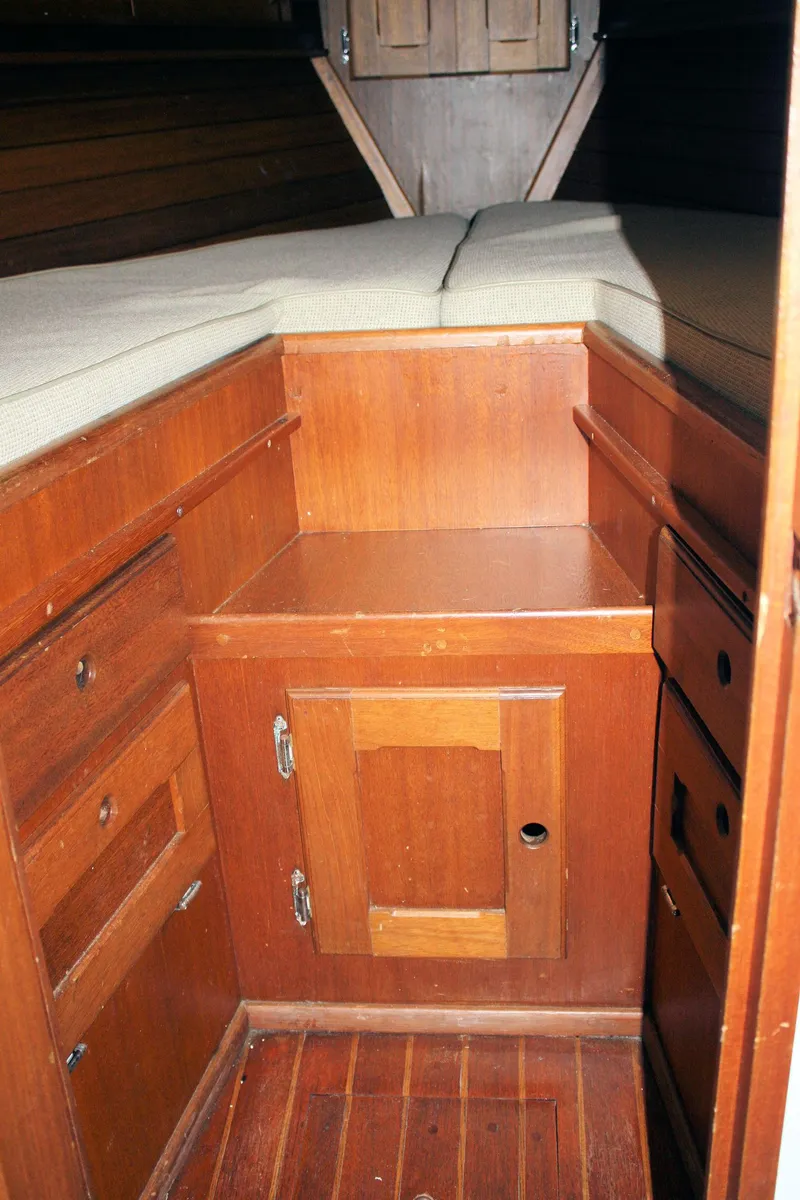 Slide: The Image of 1976 Bristol 34 yacht interior with wooden cabinetry and cushioned seating. - 32