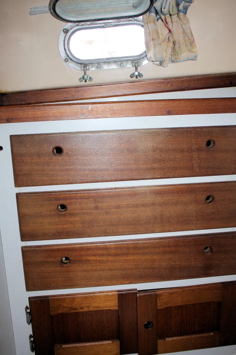 Slide: The Image of 1976 Bristol 34 interior with wooden drawers and porthole window. - 36