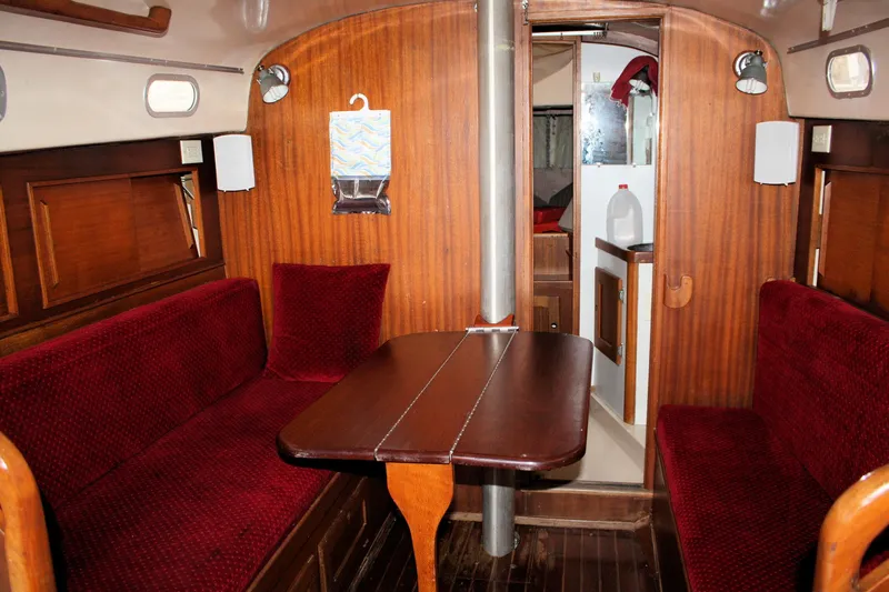 Slide: The Image of 1976 Bristol 34 yacht interior with red seating and wooden finishes. - 38