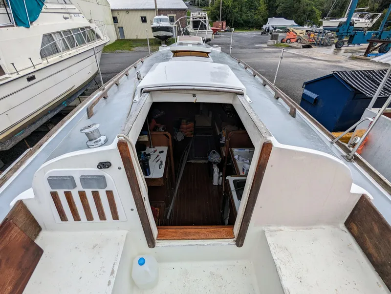 Slide: The Image of 1976 Bristol 34 sailboat interior view at a marina, showing cabin entrance and deck. - 4