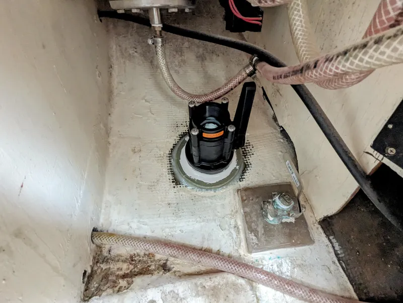Slide: The Image of Bilge pump installation in a 1976 Bristol 34 sailboat, featuring hoses and fittings. - 9