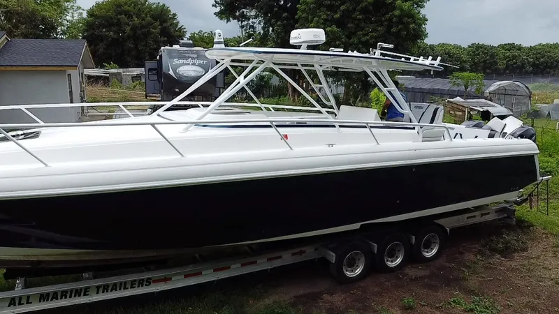 Slide: The Image of 2008 Intrepid 390 Sport Yacht on trailer, surrounded by greenery and buildings. - 29